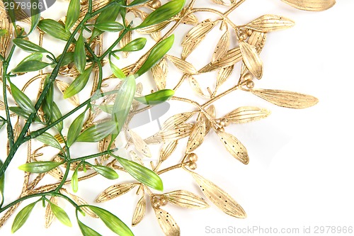 Image of green and gold christmas mistletoe background