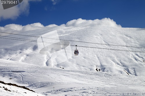 Image of Gondola lift and ski slope at sun day