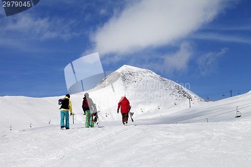 Image of Three snowboarder on slope at sun nice day