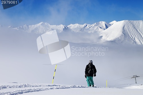 Image of Snowboarder on snowy slope with new fallen snow