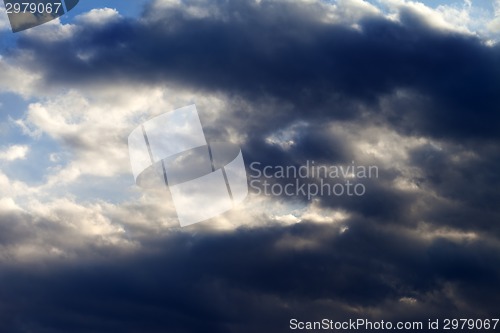 Image of Sunny sky with dark clouds