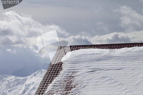 Image of Roof of hotel in snow and winter mountains