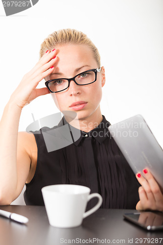 Image of Business woman working on tablet PC.