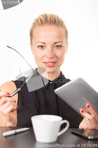 Image of Business woman working on tablet PC.