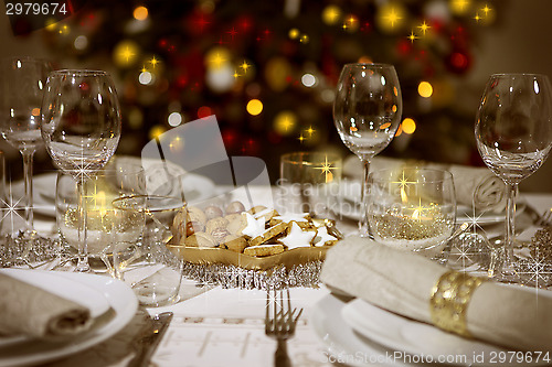 Image of laid table with christmas tree