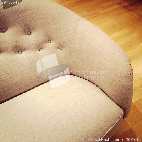 Image of Fashionable sofa on wooden floor