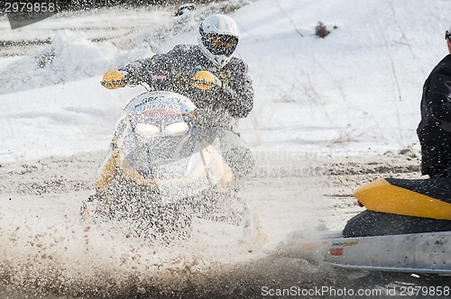 Image of Snowmobile moves on bend of sport track