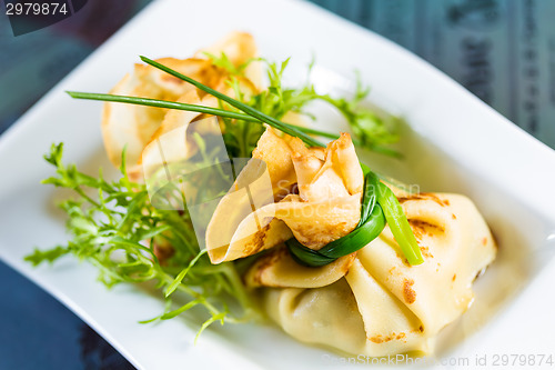 Image of pancakes with meat decorated green onions