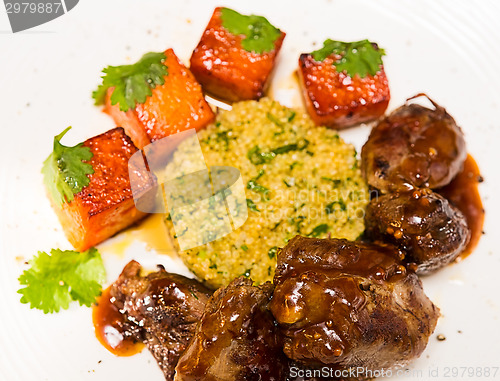 Image of Organic meat of lamb cooked with slices pumpkin and quinoa in oriental style