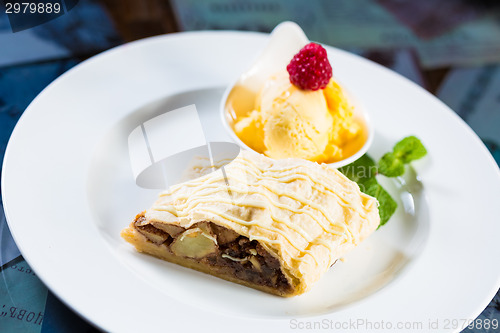 Image of Apple strudel with icing sugar,almonds and vanilla ice cream
