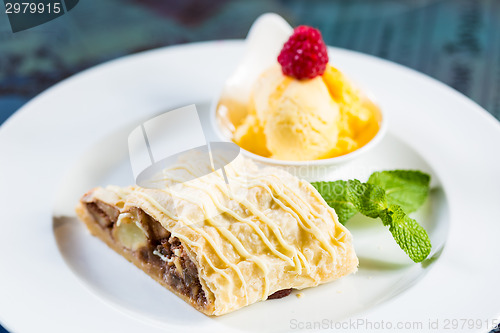Image of Apple strudel with icing sugar,almonds and vanilla ice cream