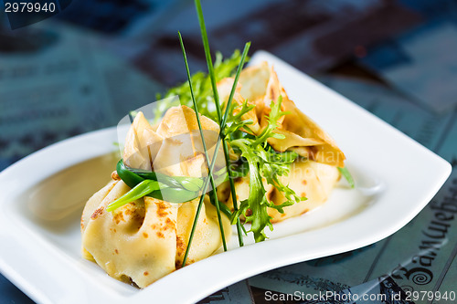 Image of pancakes with meat decorated green onions