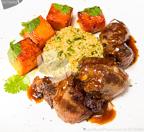 Image of Organic meat of lamb cooked with slices pumpkin and quinoa in oriental style