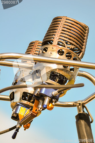 Image of hot air balloon burners on blue sky