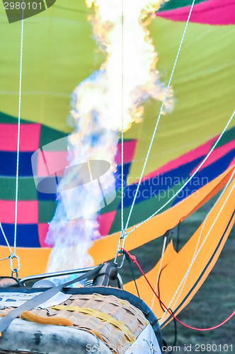 Image of Fire heats the air inside a hot air balloon at balloon festival 