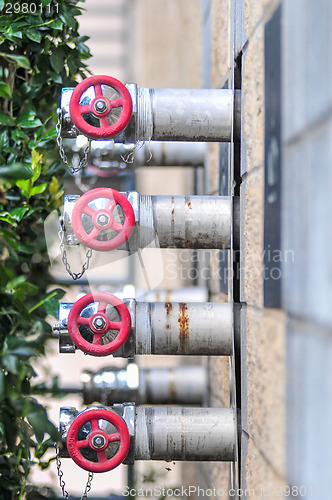 Image of multiple fire department connections on a building wall