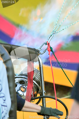 Image of Fire heats the air inside a hot air balloon at balloon festival 