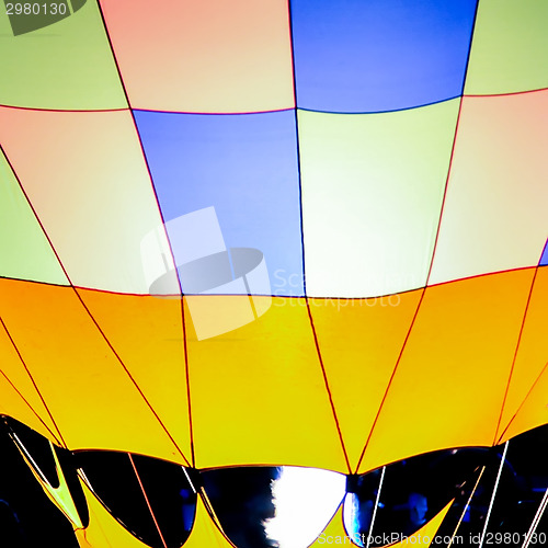 Image of Fire heats the air inside a hot air balloon at balloon festival 