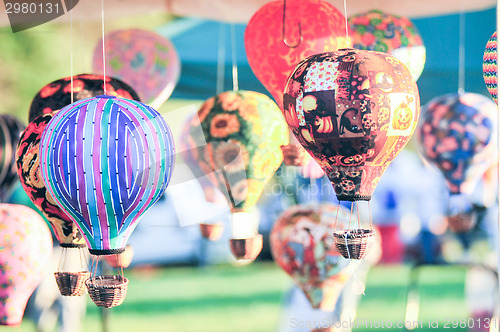 Image of bunch of hot air balloon toys dangling in the wind