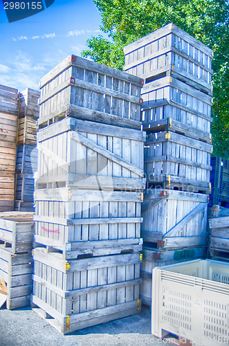 Image of Stack of fruit boxes or crates sit outside a warehouse 
