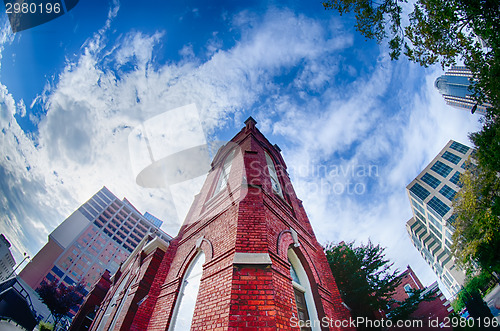 Image of old brick church abuilding in a city