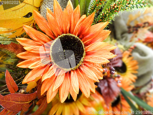 Image of fake orange sunflower on store  display