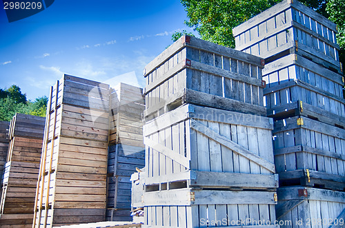 Image of Stack of fruit boxes or crates sit outside a warehouse 