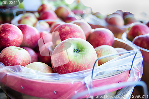 Image of Large bushel basket full of fresh locally grown red apples at lo