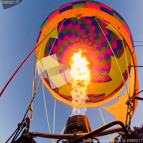 Image of Fire heats the air inside a hot air balloon at balloon festival 