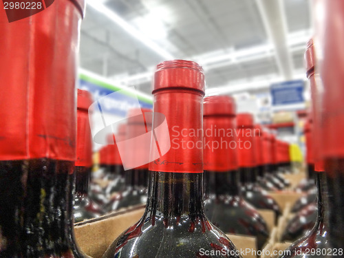 Image of wine bottles stacked on wooden racks shot with limited depth of 