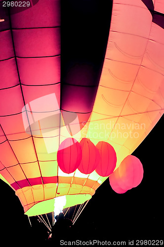 Image of Fire heats the air inside a hot air balloon at balloon festival 