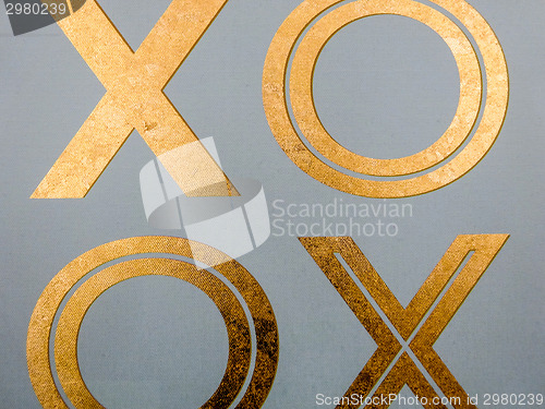 Image of golden xoxo letters on canvas board