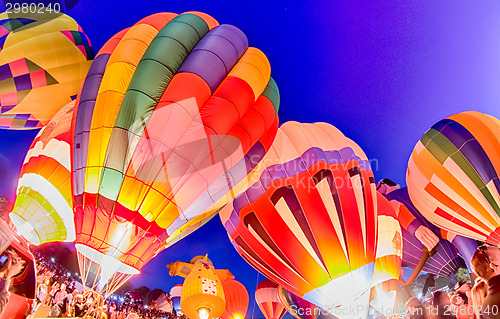 Image of Bright Hot Air Balloons Glowing at Night