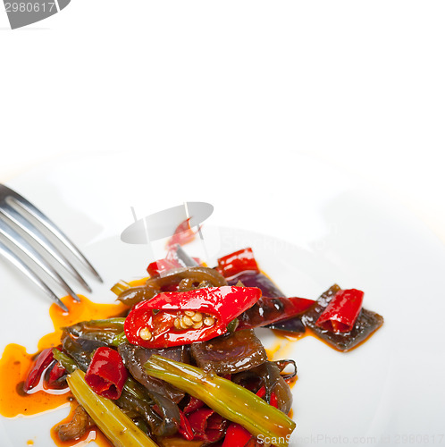 Image of fried chili pepper and vegetable on a wok pan