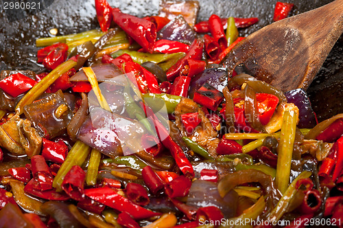 Image of fried chili pepper and vegetable on a wok pan