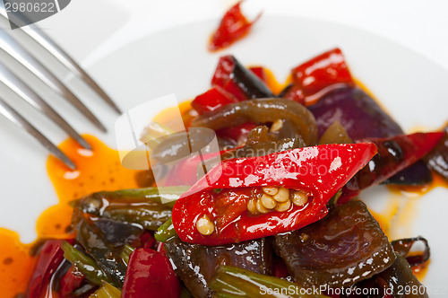 Image of fried chili pepper and vegetable on a wok pan