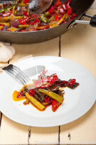 Image of fried chili pepper and vegetable on a wok pan