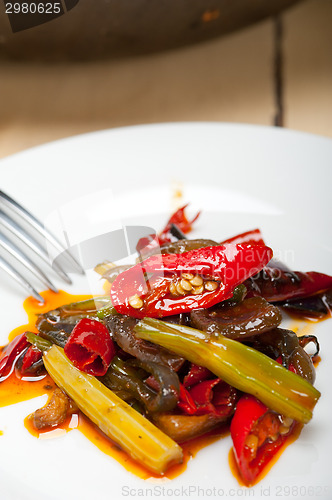 Image of fried chili pepper and vegetable on a wok pan