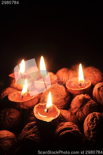 Image of candle from the walnut shells - christmas tradition