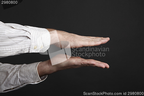 Image of Caucasian male hands squeeze something