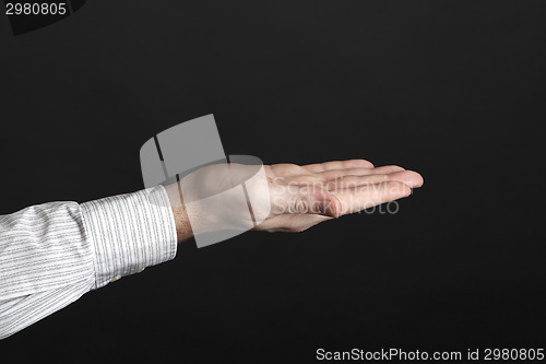 Image of Caucasian male hands hold something