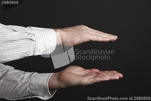 Image of Caucasian male hands protect something