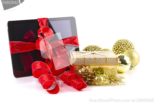 Image of tablet pc with  christmas decorations on white 