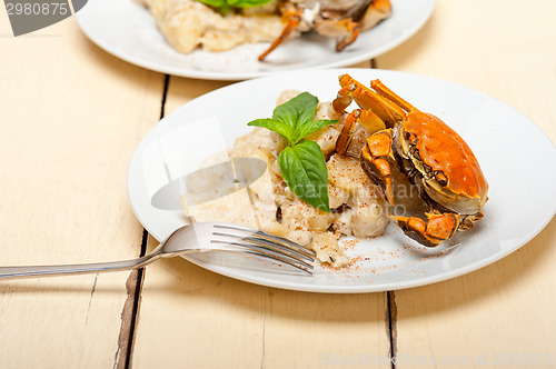 Image of Italian gnocchi with seafood sauce with crab and basil