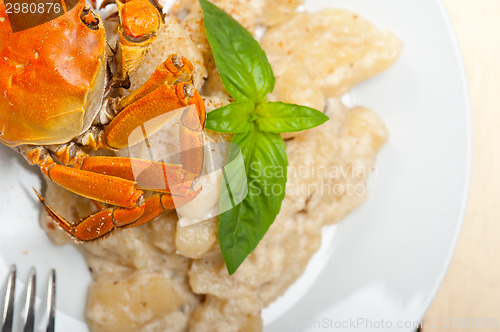 Image of Italian gnocchi with seafood sauce with crab and basil