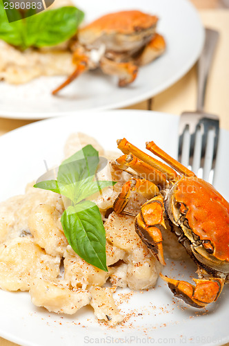 Image of Italian gnocchi with seafood sauce with crab and basil