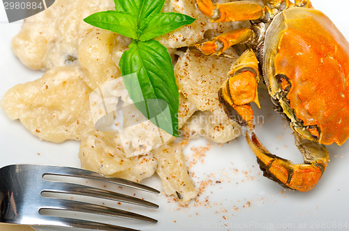 Image of Italian gnocchi with seafood sauce with crab and basil