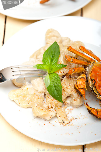 Image of Italian gnocchi with seafood sauce with crab and basil