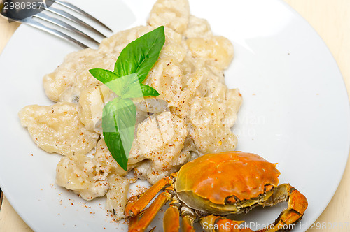 Image of Italian gnocchi with seafood sauce with crab and basil