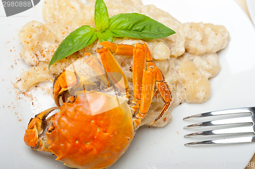 Image of Italian gnocchi with seafood sauce with crab and basil